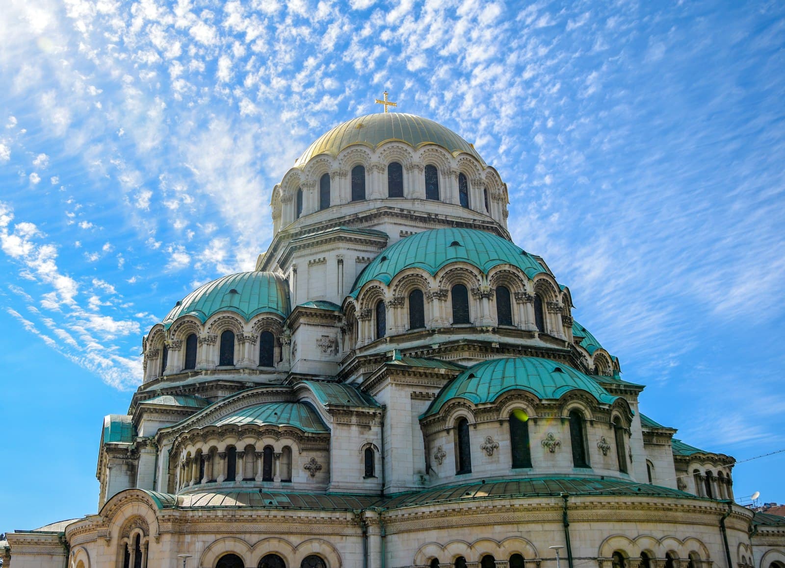 Alexander Nevsky Cathedral's green and gold domes against a blue sky in central Sofia