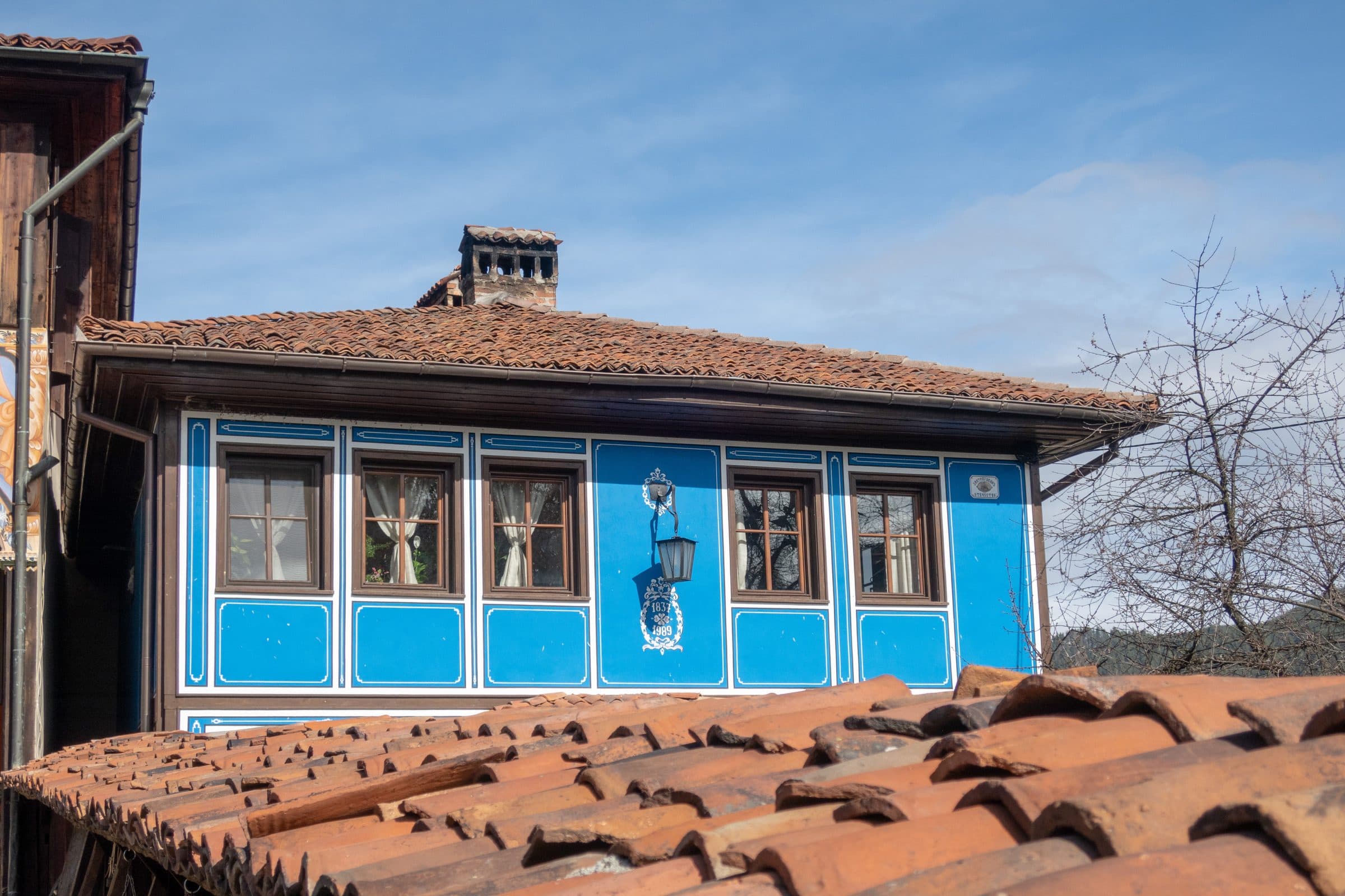 A blue National Revival-era house with a red tile roof in Koprivshtitsa's historic centre